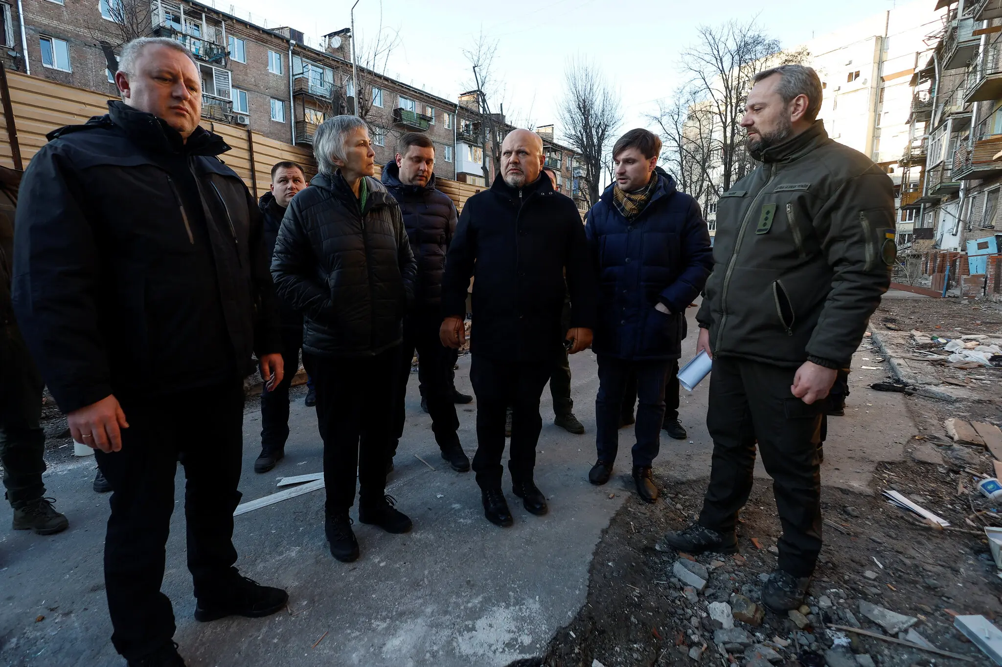 Прокурор МКС Карім Хан (у центрі) відвідує місце будівництва житлового будинку цього місяця у Вишгороді, поблизу Києва, Україна. Наприкінці листопада його пошкодив російський ракетний удар.